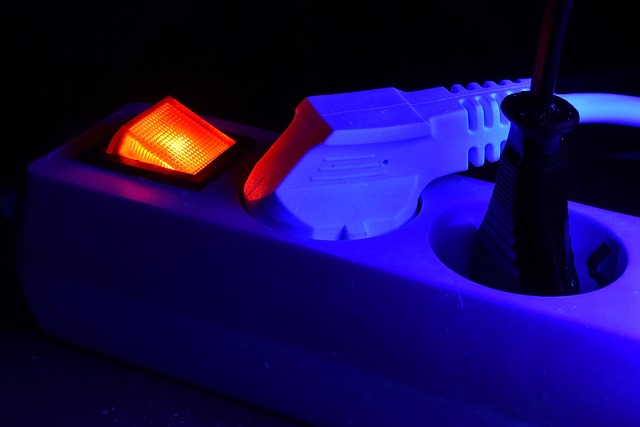 macro photo of hot-swappable mechanical keyboard sockets and switch pins with crimson lighting, no people